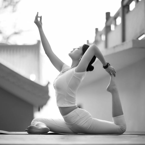 A person sitting in a meditative yoga pose in a tranquil natural setting.